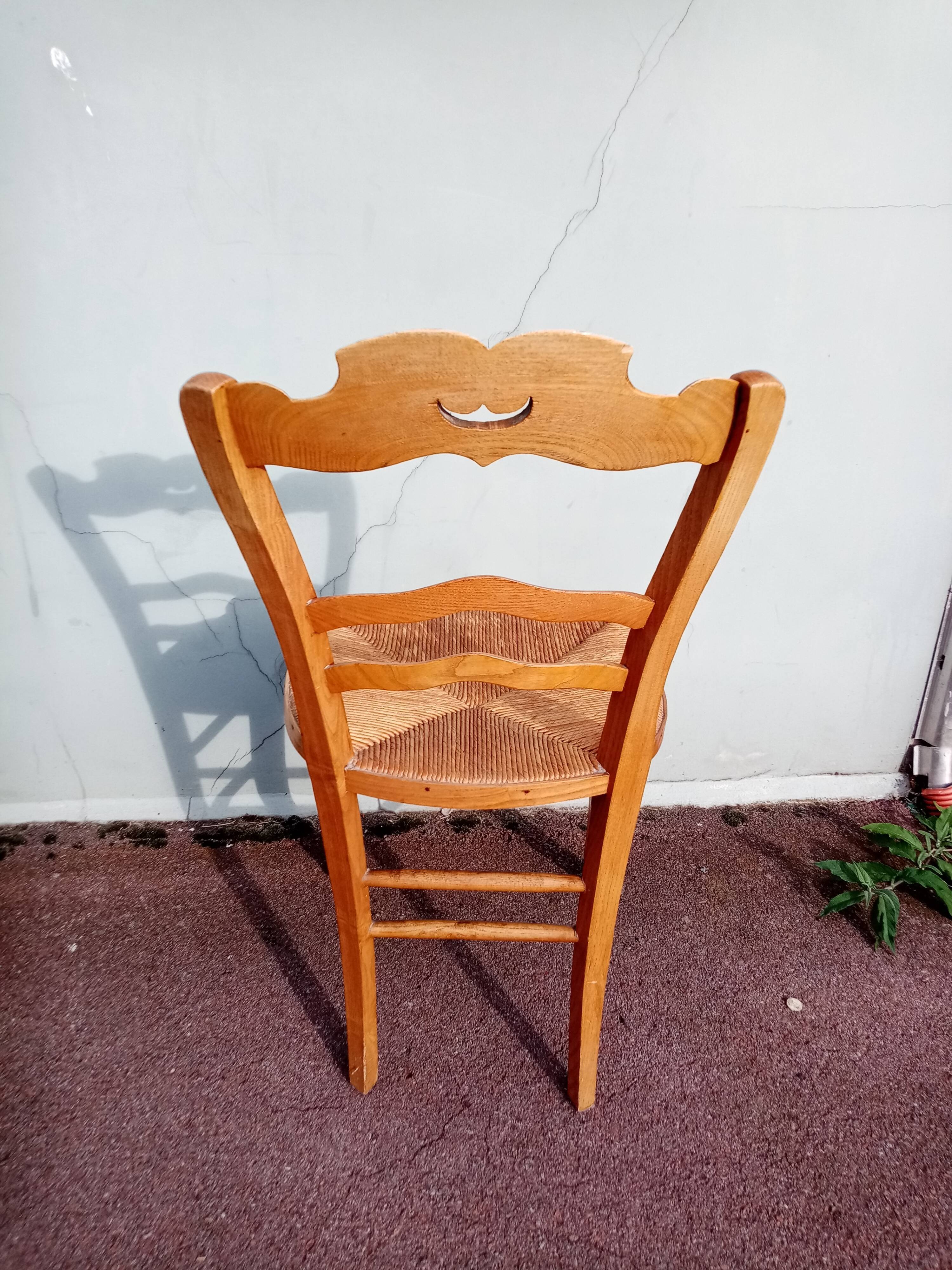 Antique wooden chair seated straw mustache