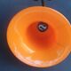 Art Deco wall light in brass with an orange globe.