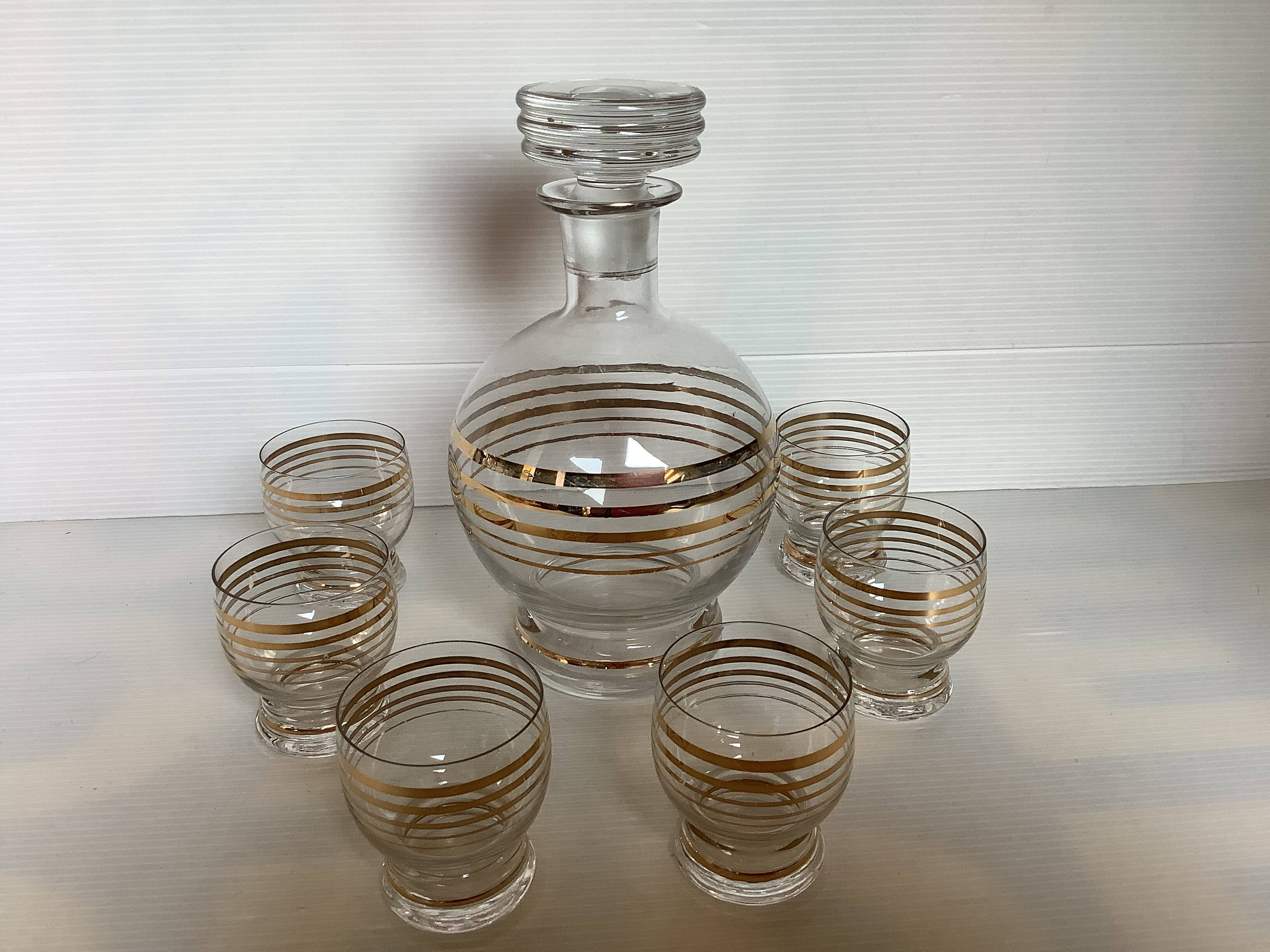 Antique liqueur set with a gold rim.