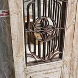 Chiseled teak door with openwork wrought iron panels