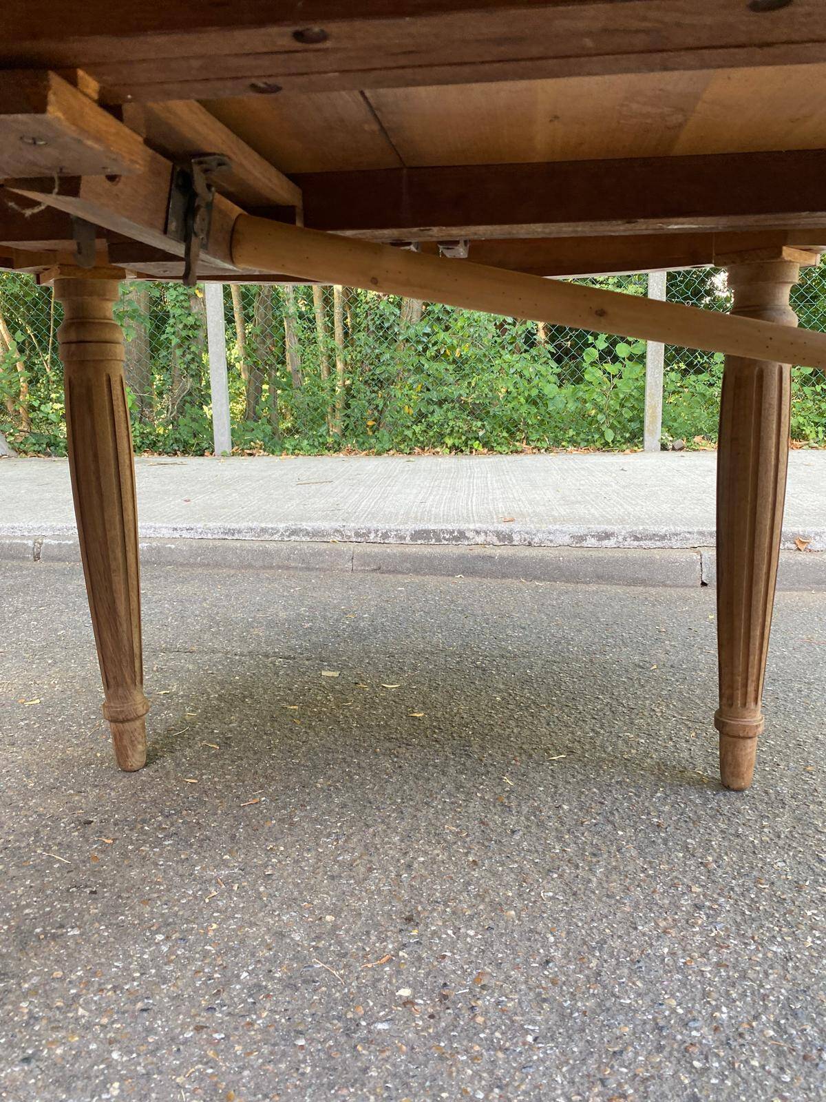 Art Deco round extendable dining table stripped in solid walnut from the 1920s.