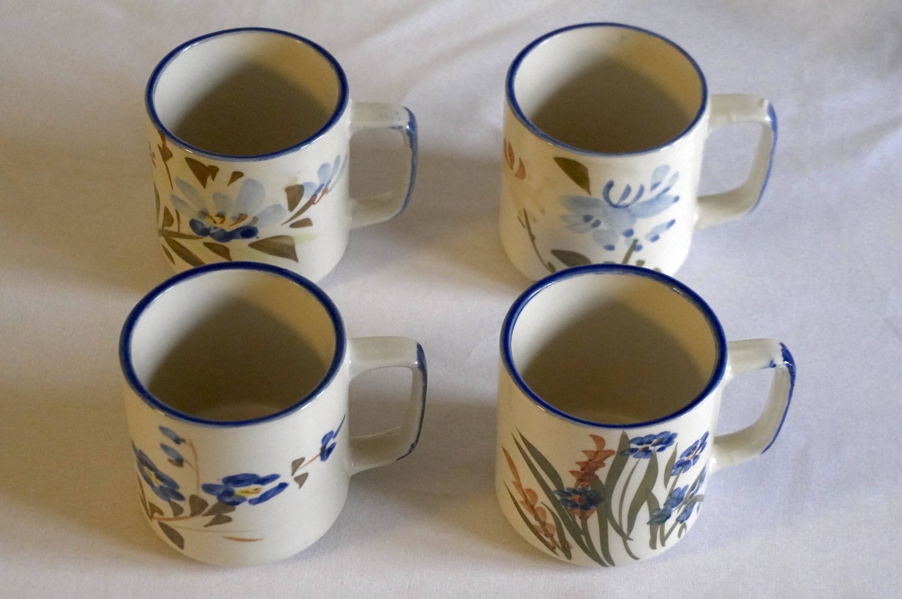 Set of 4 stoneware cups/mugs with blue floral designs, made in China.