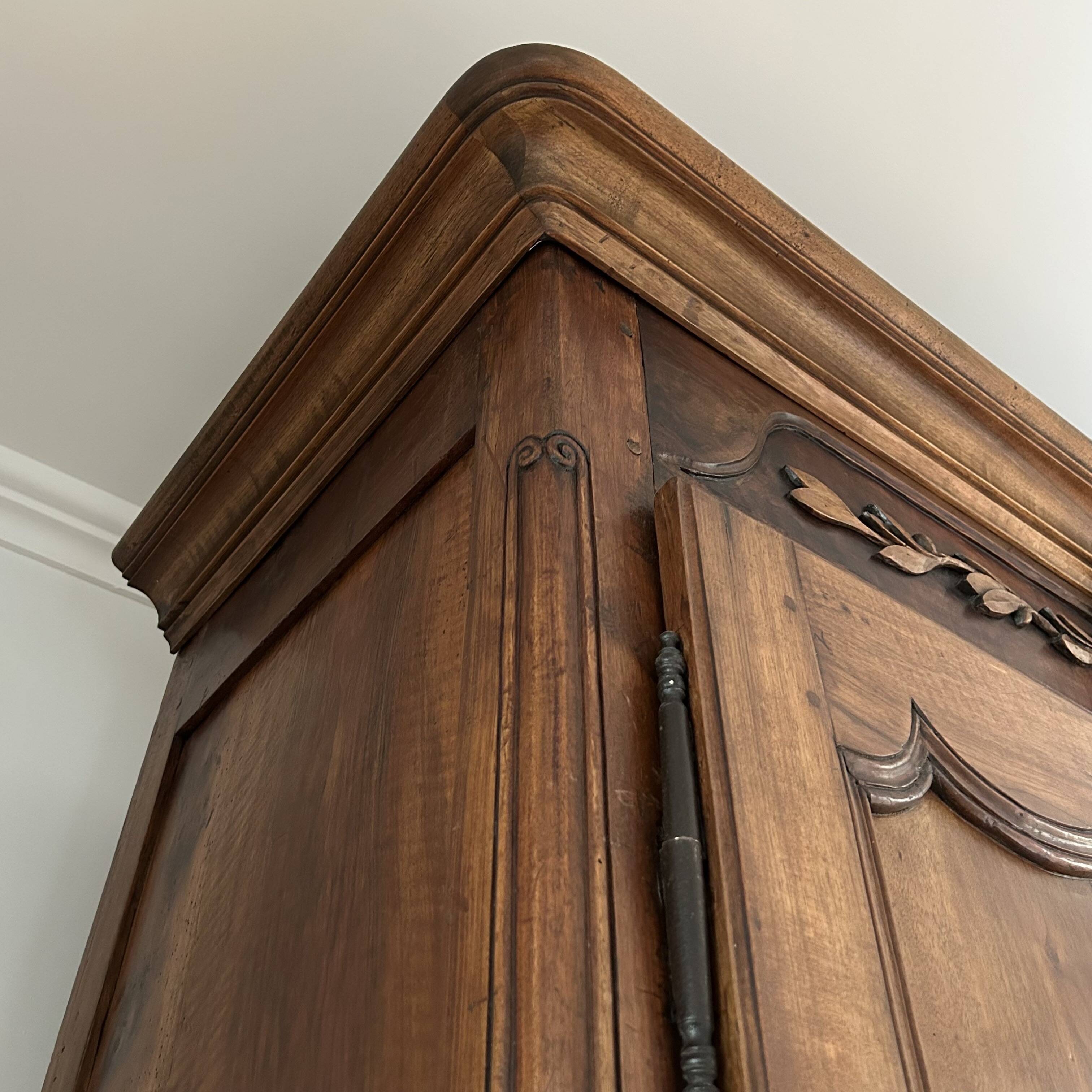 Antique walnut armoire with two doors.