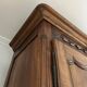 Antique walnut armoire with two doors.