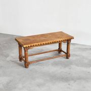 Brutalist coffee table in solid oak, metal, and patinated leather, 1940s.