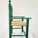 Small vintage children's chair in wood and green straw