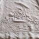 Antique embroidered linen sheet with a monogram.