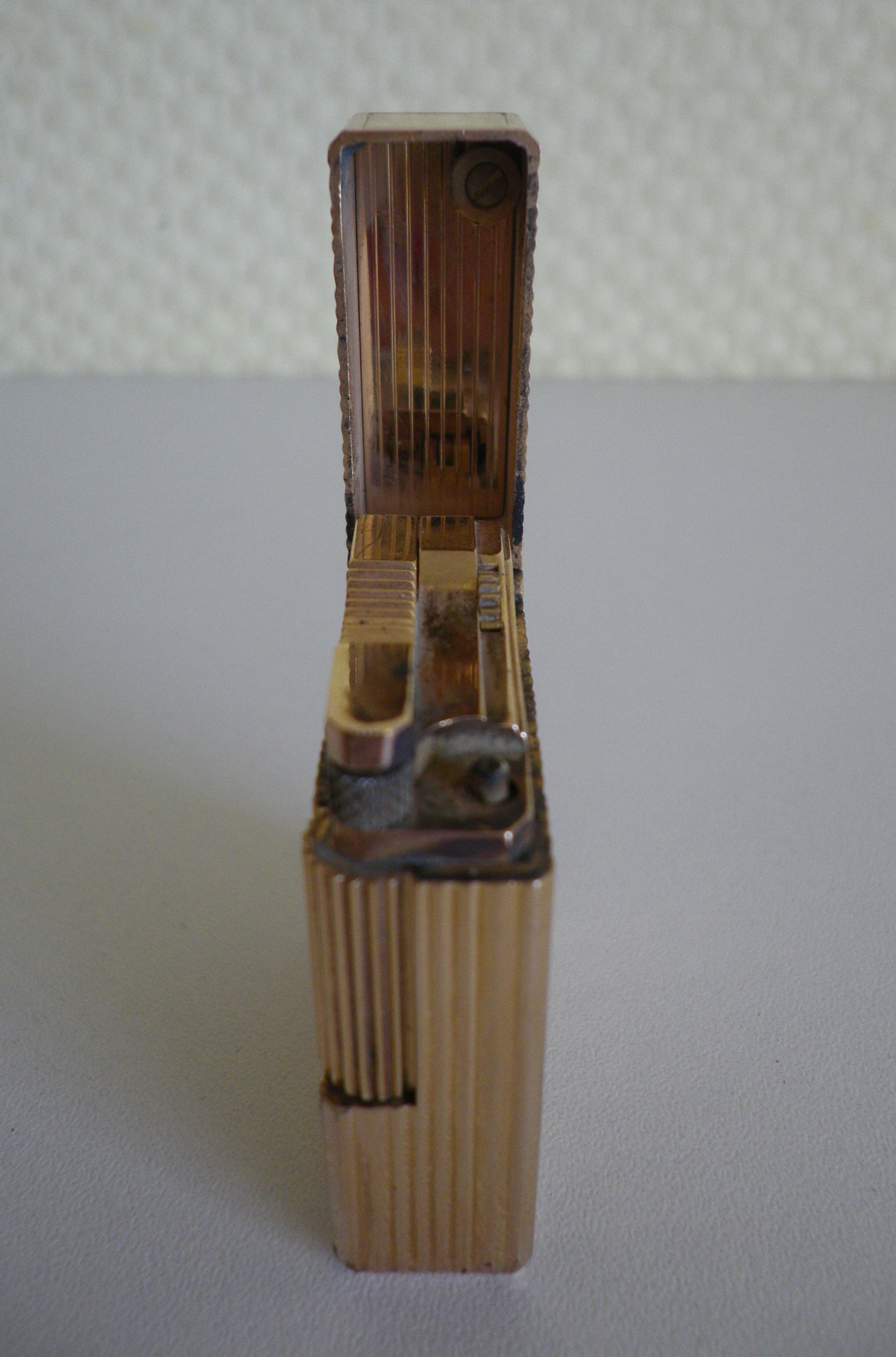 2 st dupont lighters, gold plated, punches, numbered, 1 striated pattern, 1 hammered pattern, 70s
