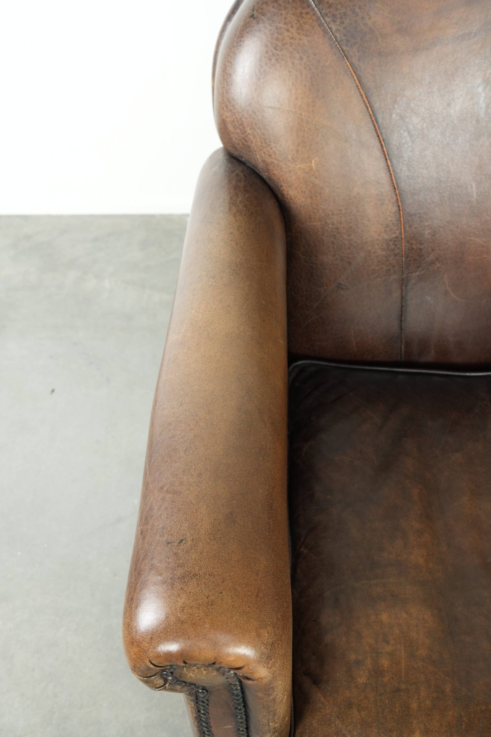 Armchair / lounge chair made of sheepskin leather with characterful patina