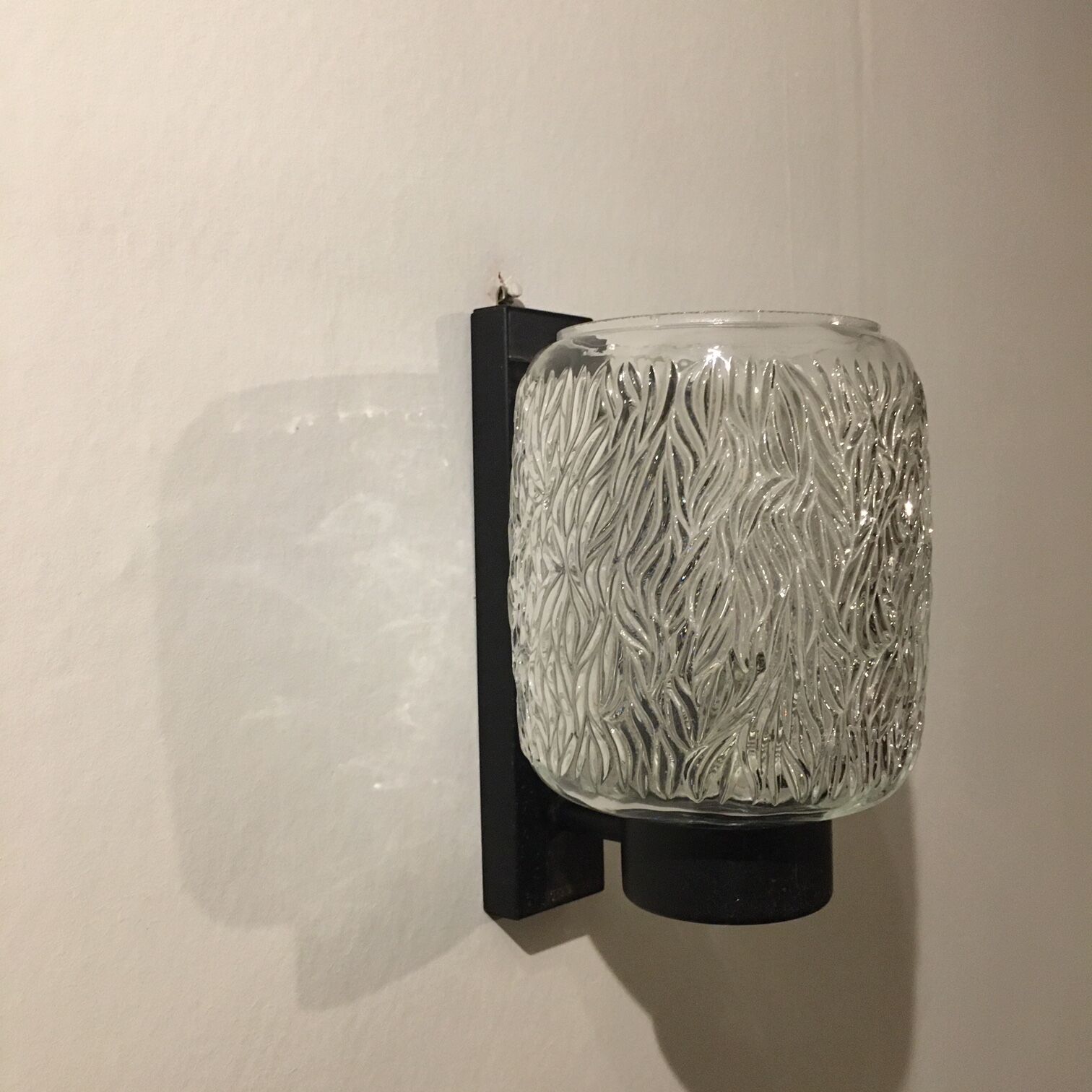 Black metal and molded glass wall sconce