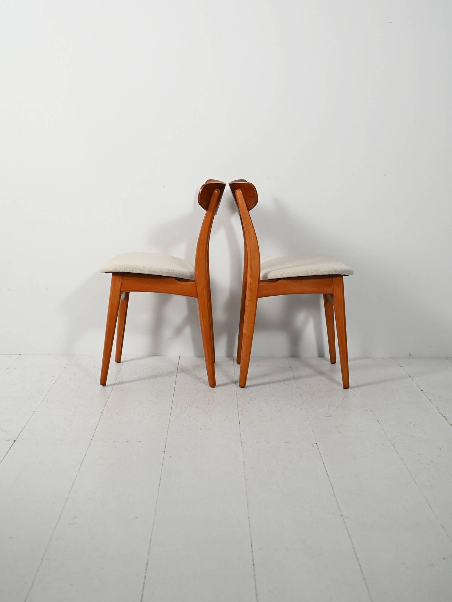 Pair of vintage teak chairs with a curved backrest