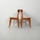 Pair of vintage teak chairs with a curved backrest