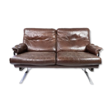 Two seater sofa upholstered with patinated brown leather and frame in metal, designed by Arne Norell