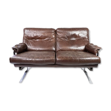 Two seater sofa upholstered with patinated brown leather and frame in metal, designed by Arne Norell