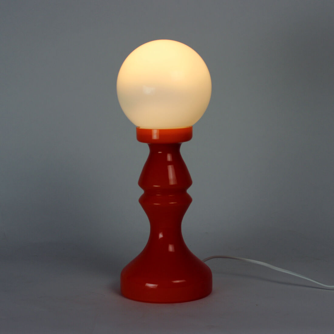 Orange glass table lamp by vitropol, poland 1960s