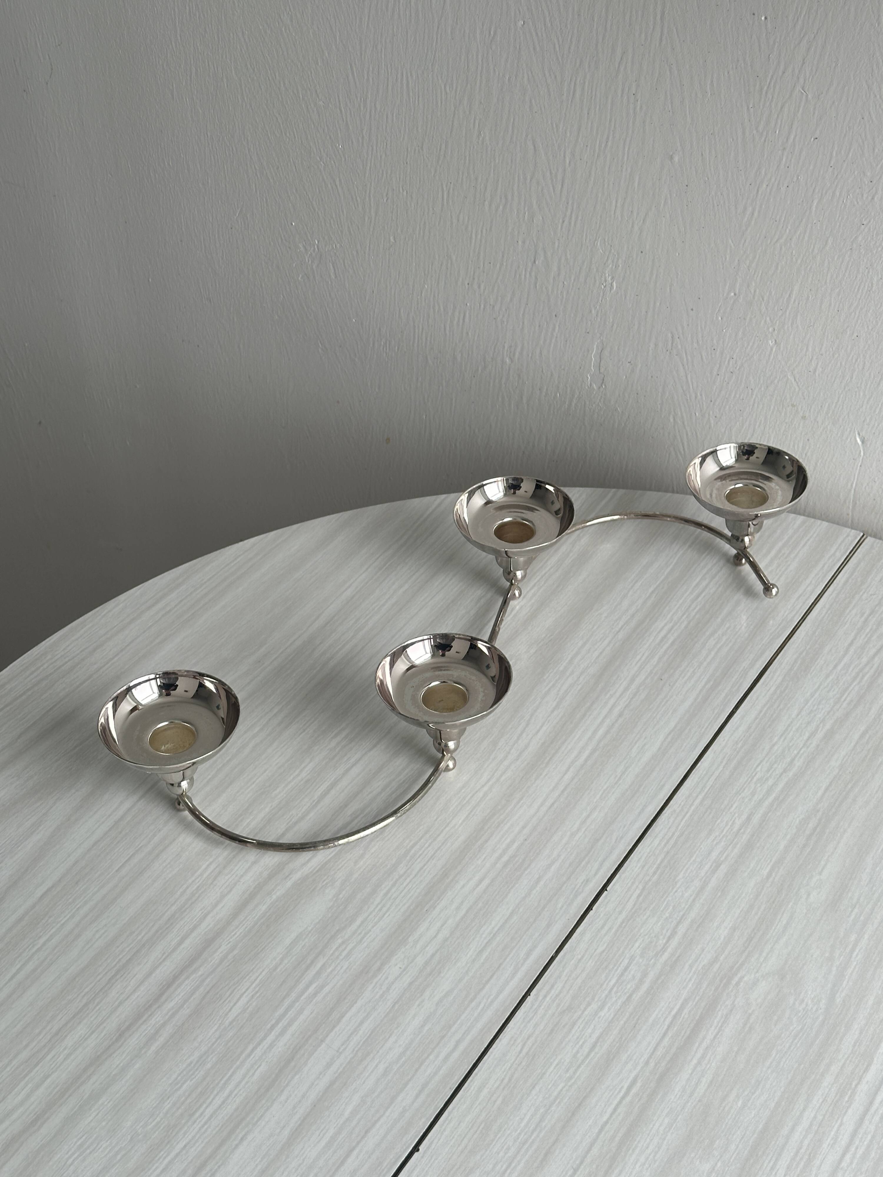 Shiny stainless steel candlestick holder