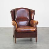 Comfortable, elegant, stately wing chair made of sheepskin in a beautiful warm color