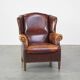 Comfortable, elegant, stately wing chair made of sheepskin in a beautiful warm color