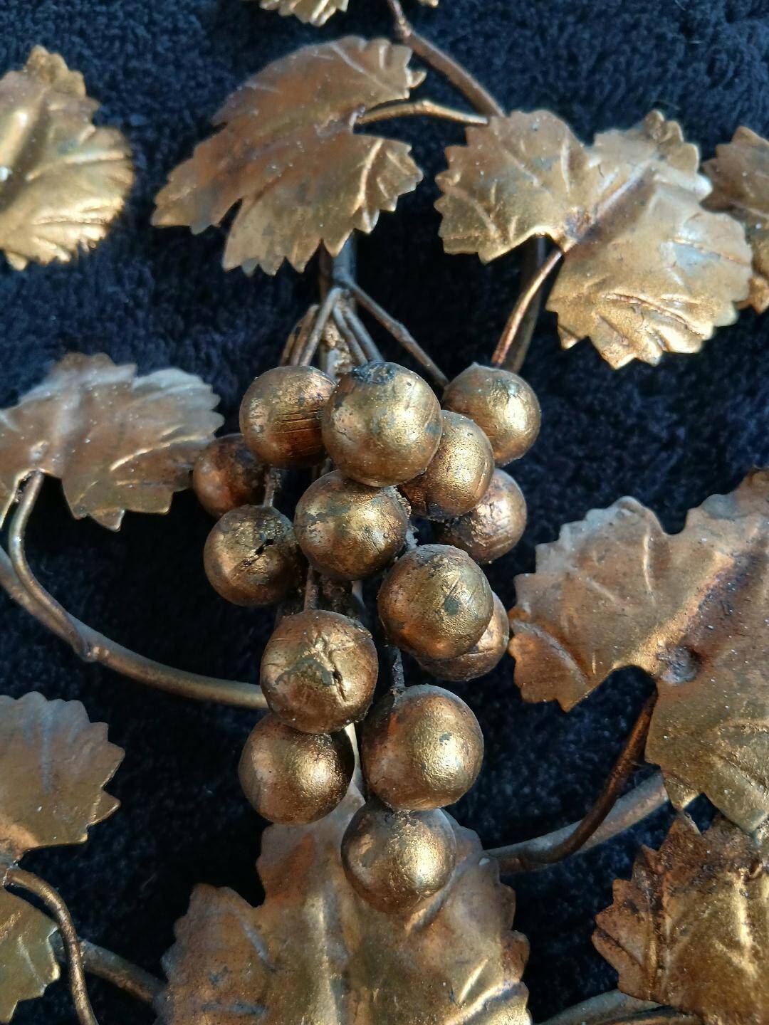 Stunning vintage wall lights in gilded iron with vine and grape decor from Italy.