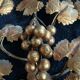 Stunning vintage wall lights in gilded iron with vine and grape decor from Italy.