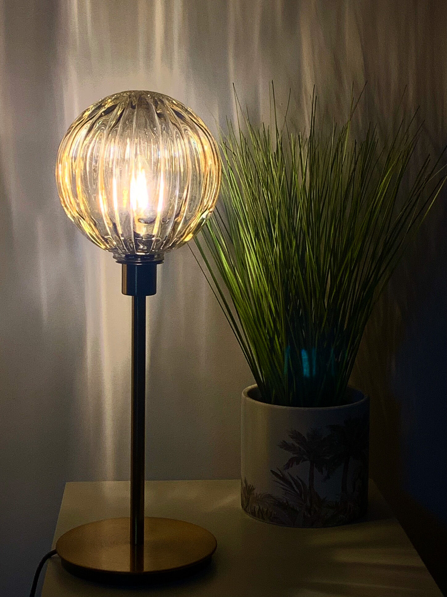 Table lamp with an antique golden streaked globe and a golden foot