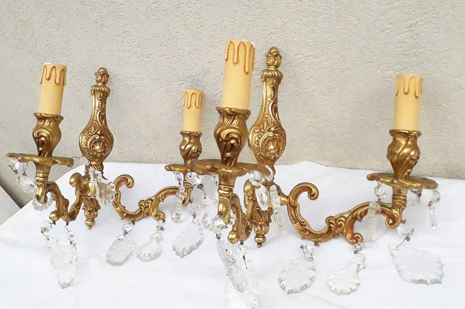 pair of bronze wall lights with pendants