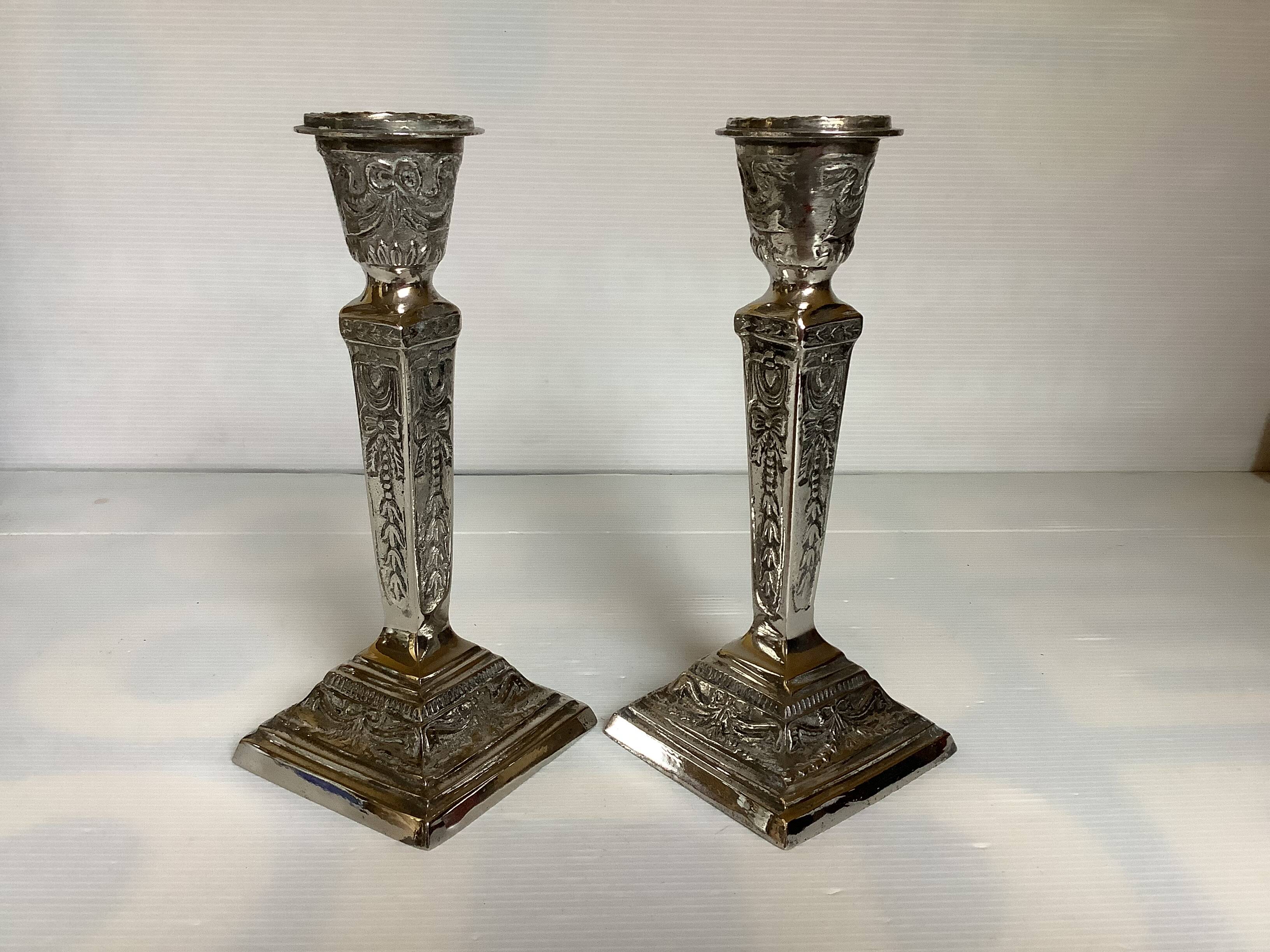 Pair of ornate silver candlesticks
