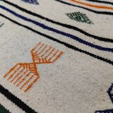 White carpet with multicolored Berber patterns woven hands