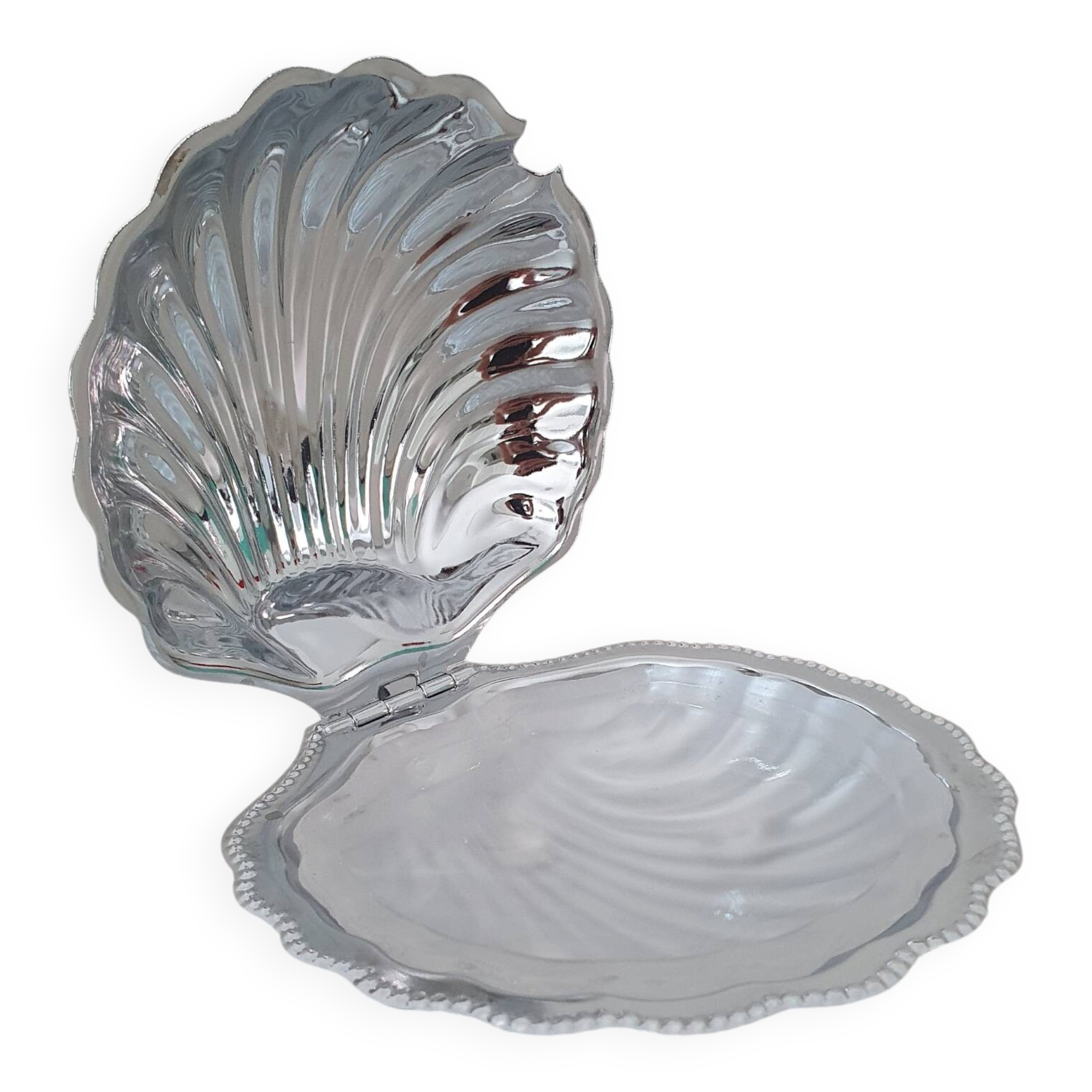 Shell-shaped butter dish in stainless steel and white glass bowl.