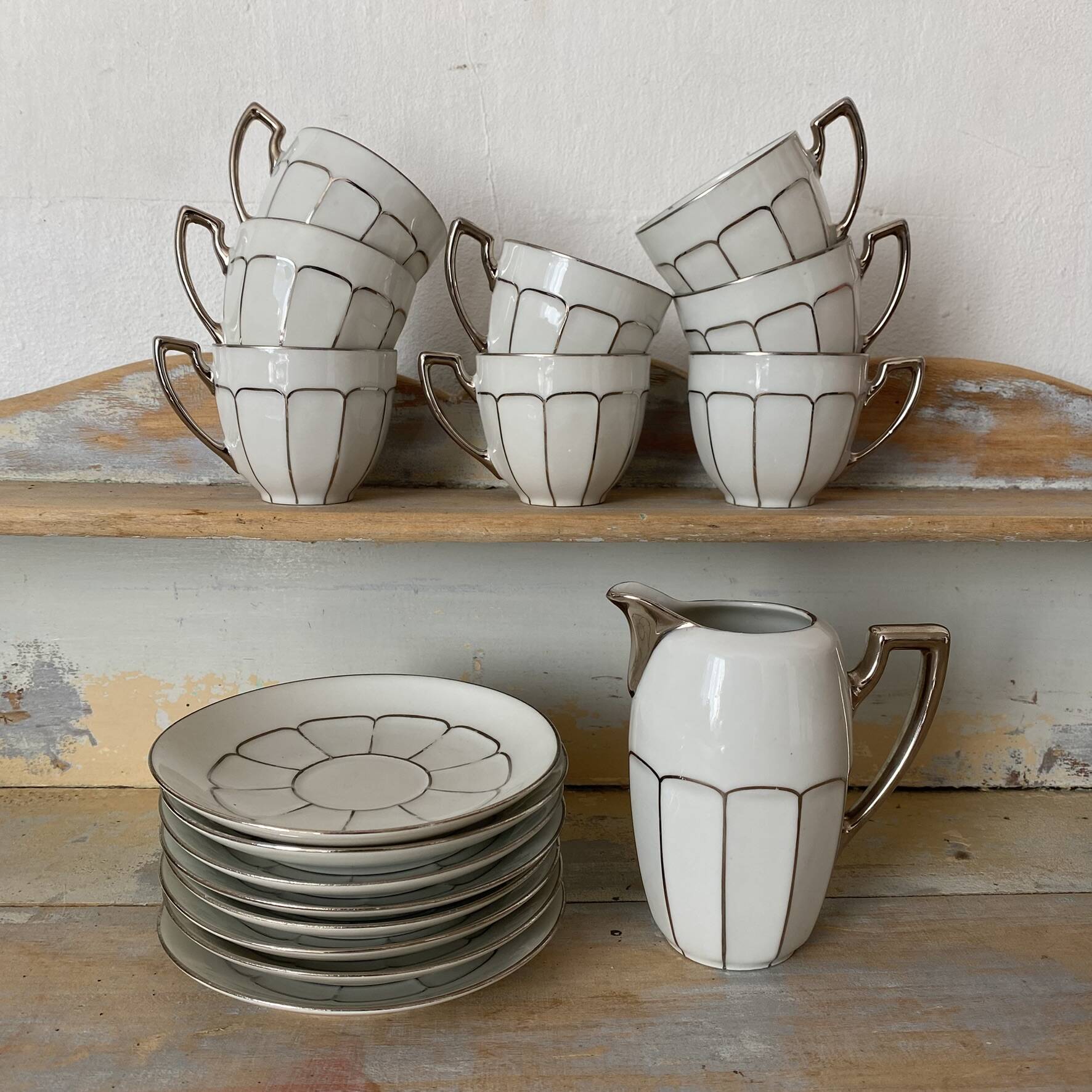 White and silver Limoges porcelain coffee cups and saucers.