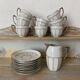 White and silver Limoges porcelain coffee cups and saucers.