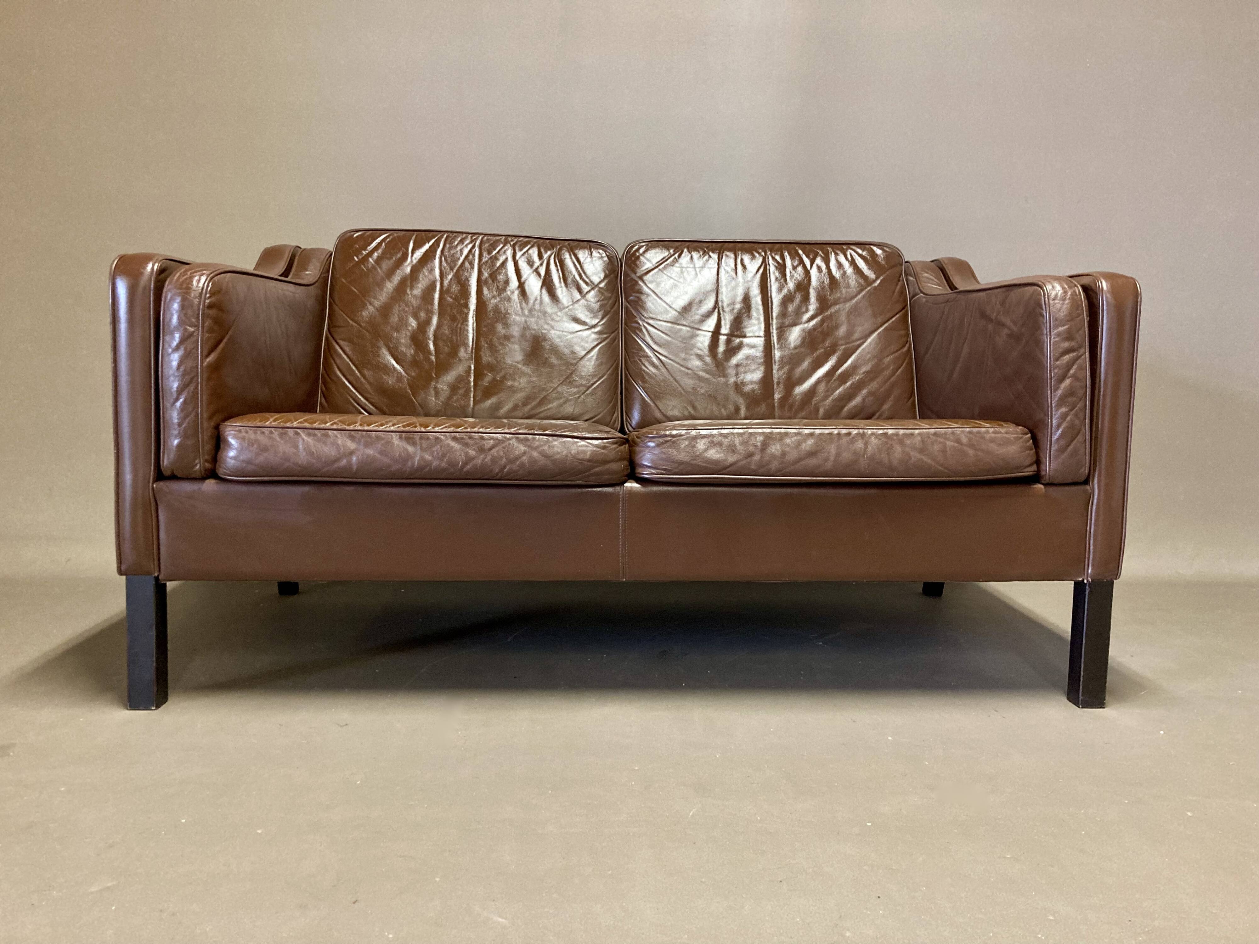 Scandinavian design 2-seater leather sofa.