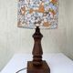 Vintage turned wood table lamp with floral drum shade.