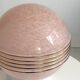 Art Deco lamp with a speckled pink glass globe and a white ceramic base.