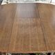 Round wooden table with 1 integrated extension + 6 wooden and fabric chairs