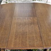 Round wooden table with 1 integrated extension + 6 wooden and fabric chairs