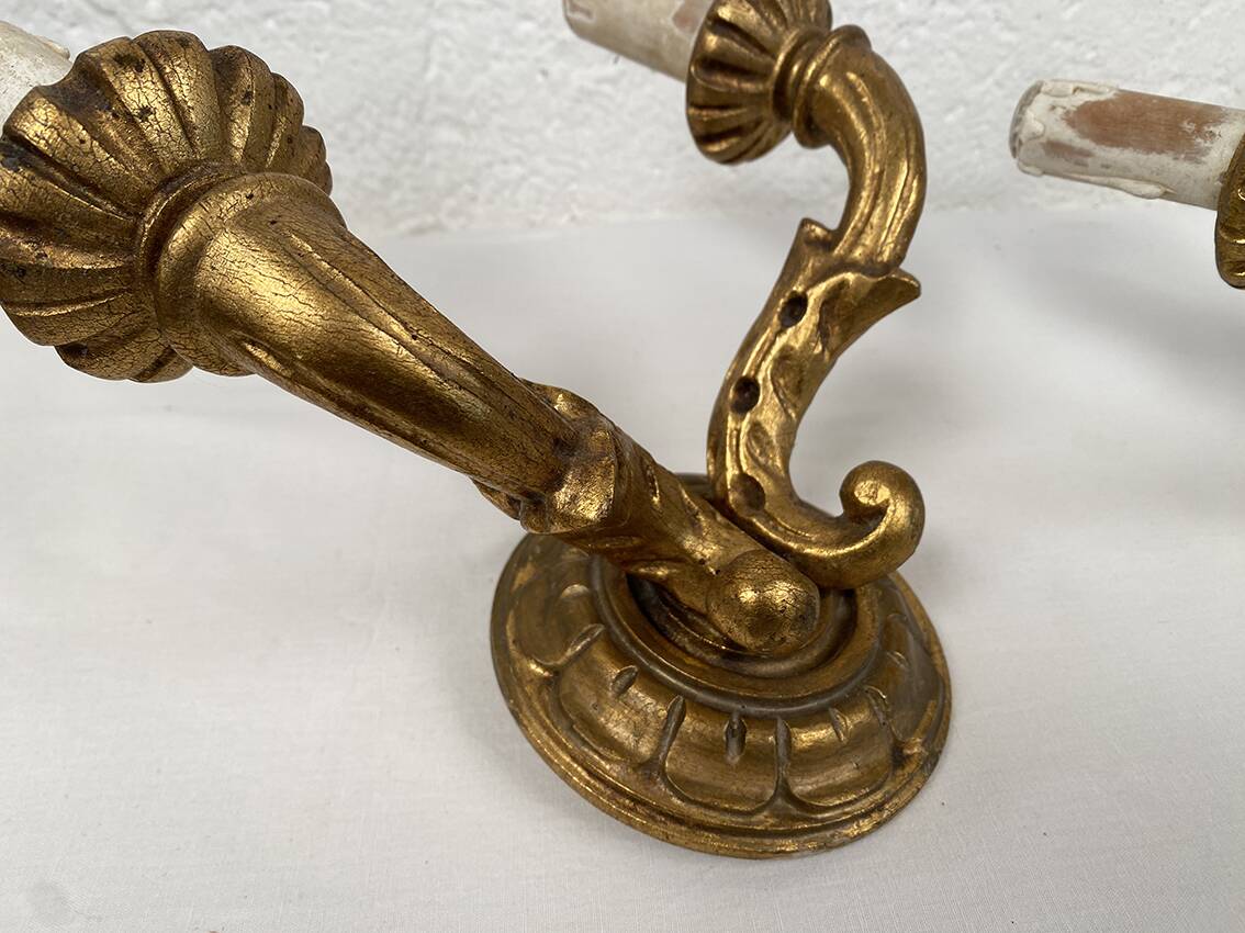 Pair of gilded wooden wall lights with two arms, early 20th century.