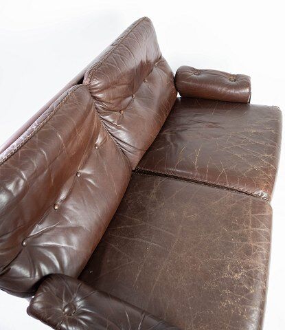 Two seater sofa upholstered with patinated brown leather and frame in metal, designed by Arne Norell
