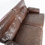 Two seater sofa upholstered with patinated brown leather and frame in metal, designed by Arne Norell