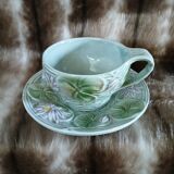 Antique cup and saucer in majolica.