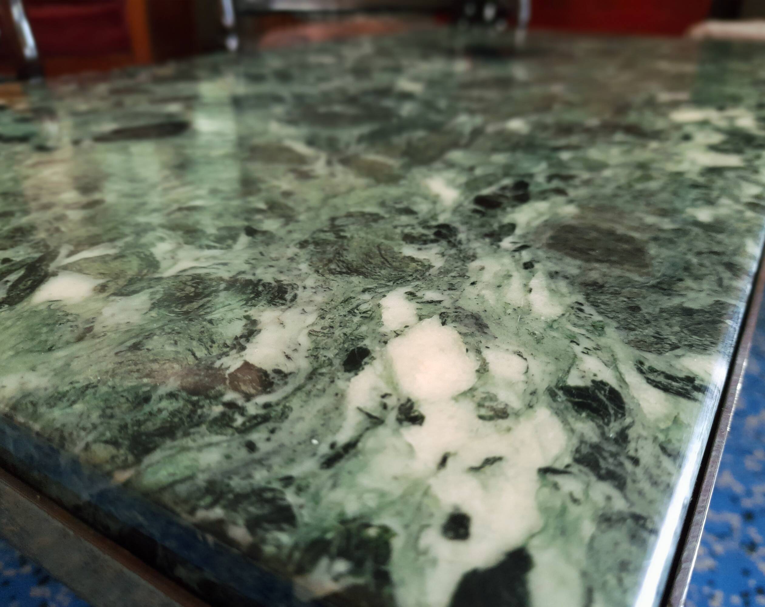 Coffee table in gilded bronze and green Alpine marble