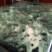 Coffee table in gilded bronze and green Alpine marble
