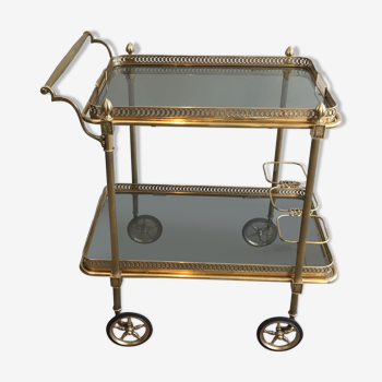 Neoclassical style rolling table in brass with blue glass tops