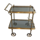 Neoclassical style rolling table in brass with blue glass tops