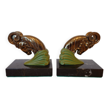 Art Deco pair of bookends with ram's heads, patinated metal and black marble.