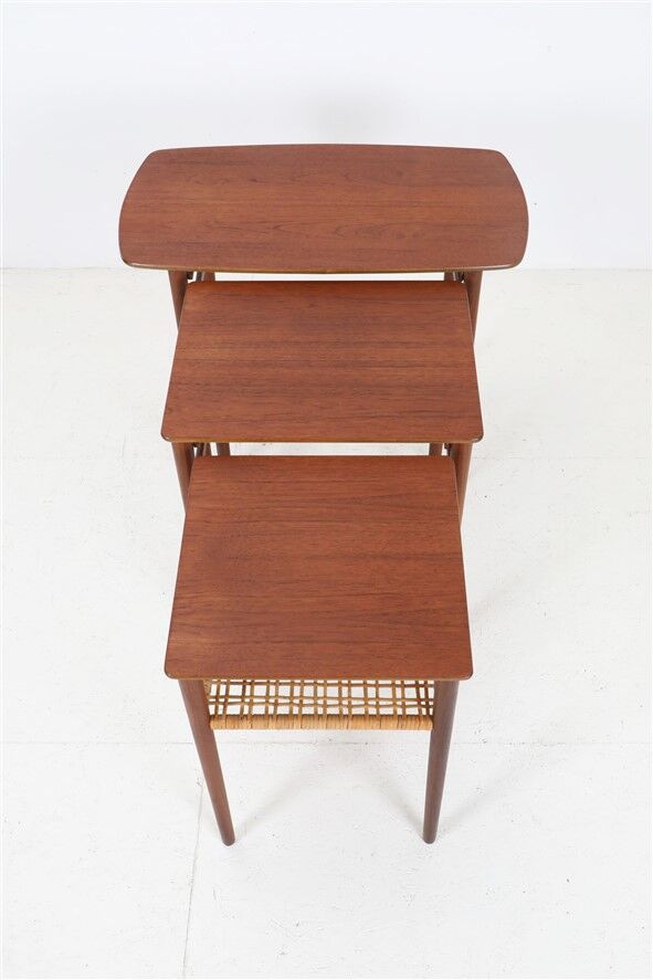 Rare set of three teak nesting tables with cane magazine rack / side tables / mid-century Danish modern design / 1950s / 1960s