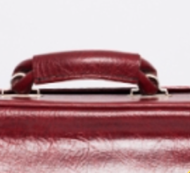 Red faux leather suitcase