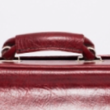 Red faux leather suitcase