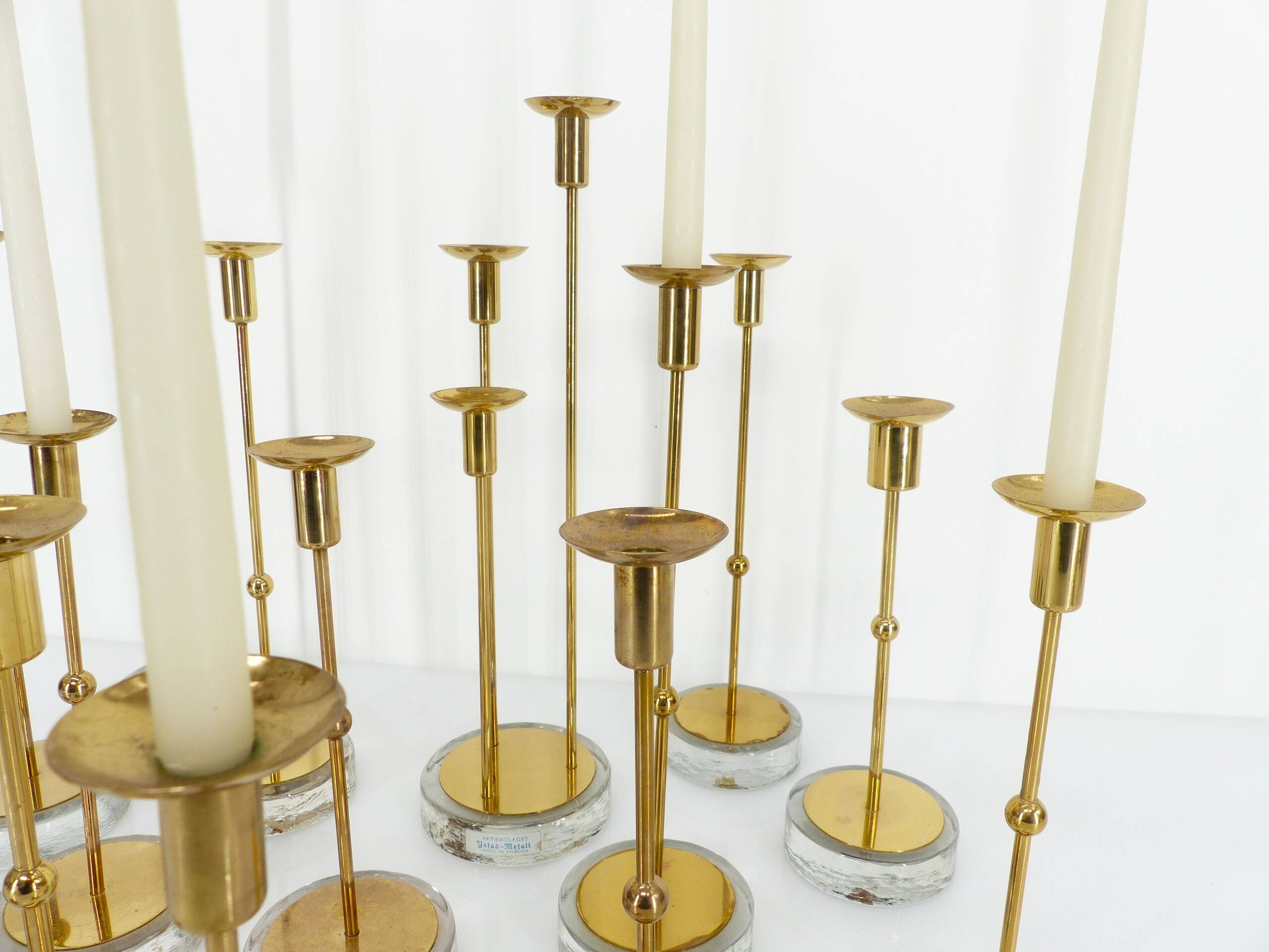Set of 15 Scandinavian candle holders in brass and glass, Gunnar Ander, Ystad Met
