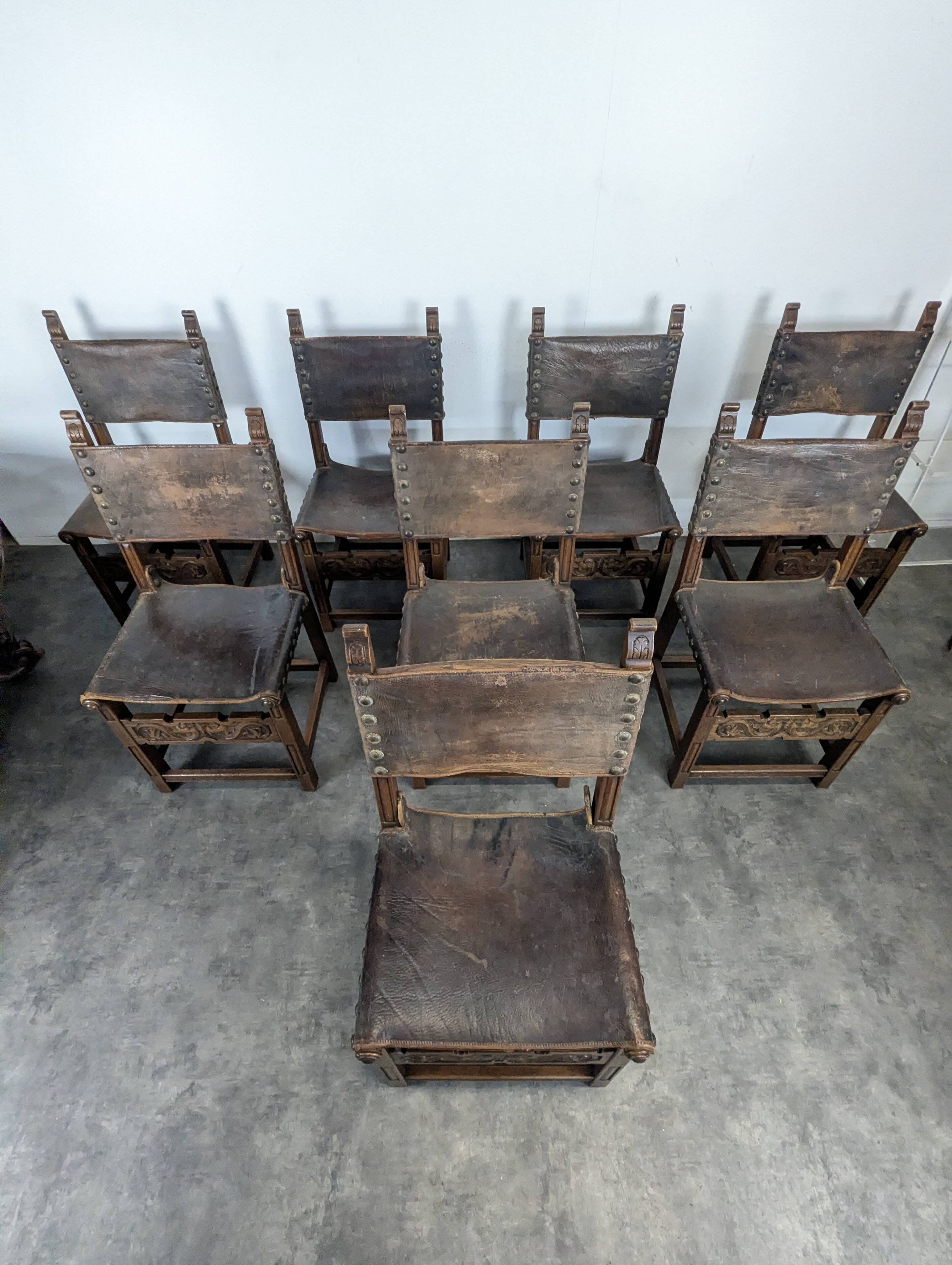Set of 8 Gothic-style chairs in oak and studded leather.